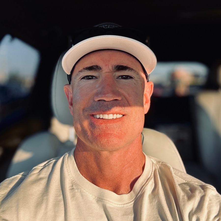 Andrew, founder of Vibe HAUS, smiling in a white cap